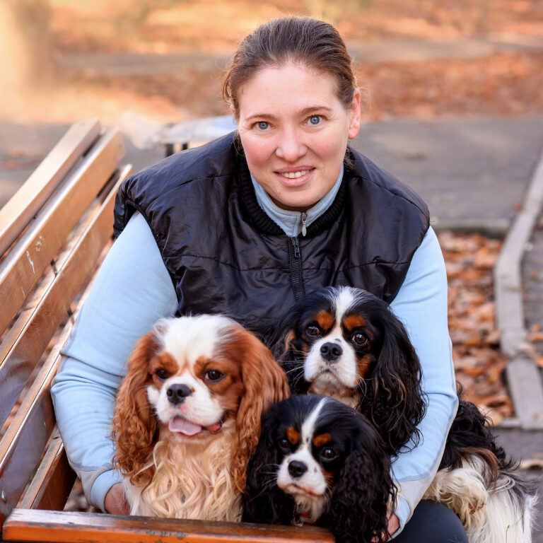 Home, About, Breeder sitting with dogs